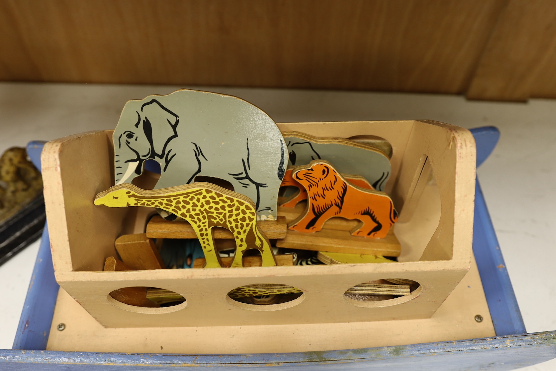 A painted ply Noah's Ark with animals, two Victorian iron door stops, a painted toleware cockerel and an oil on canvas of a harbour view. Condition - varies